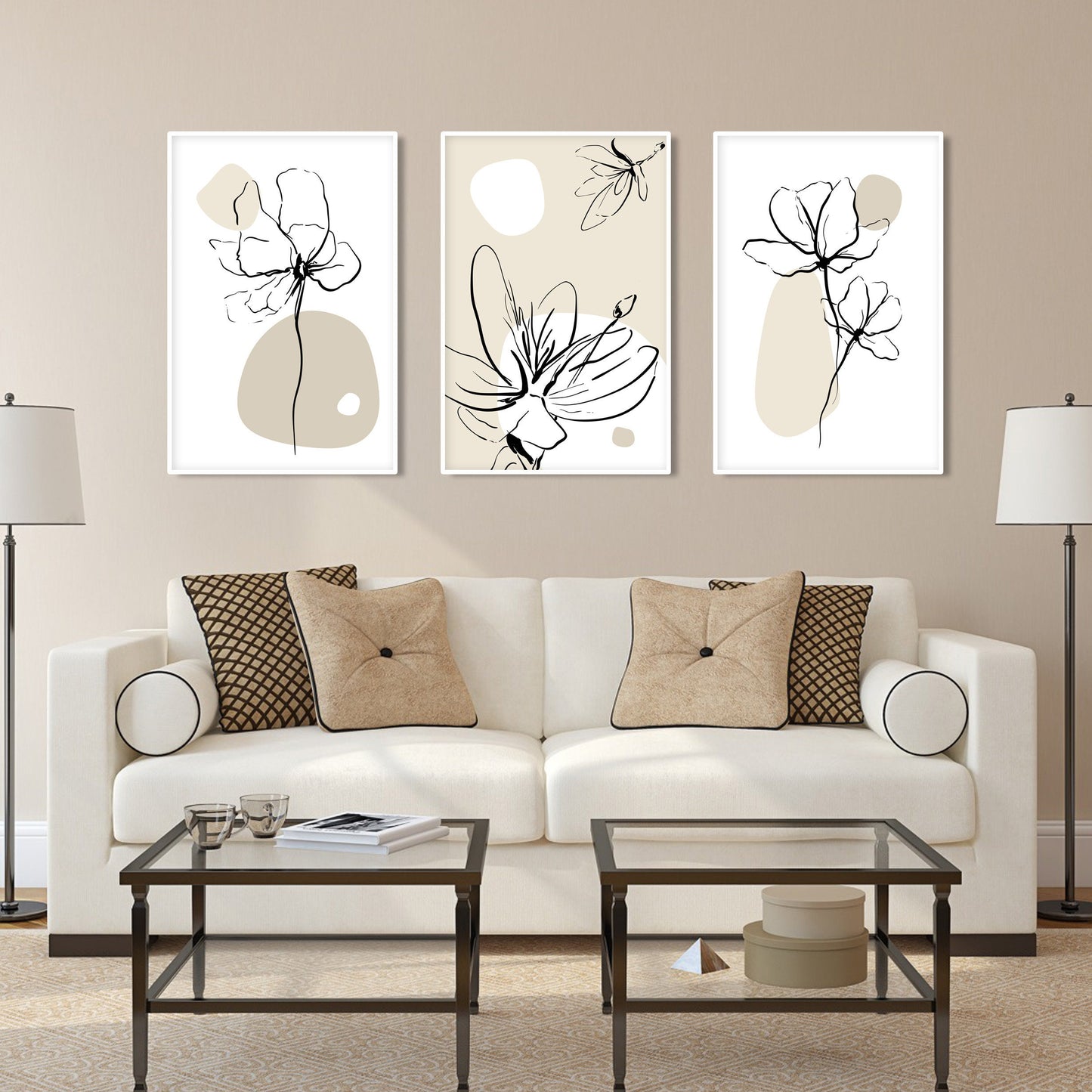 Boho floral line art trio in white frames arranged above a beige sofa
