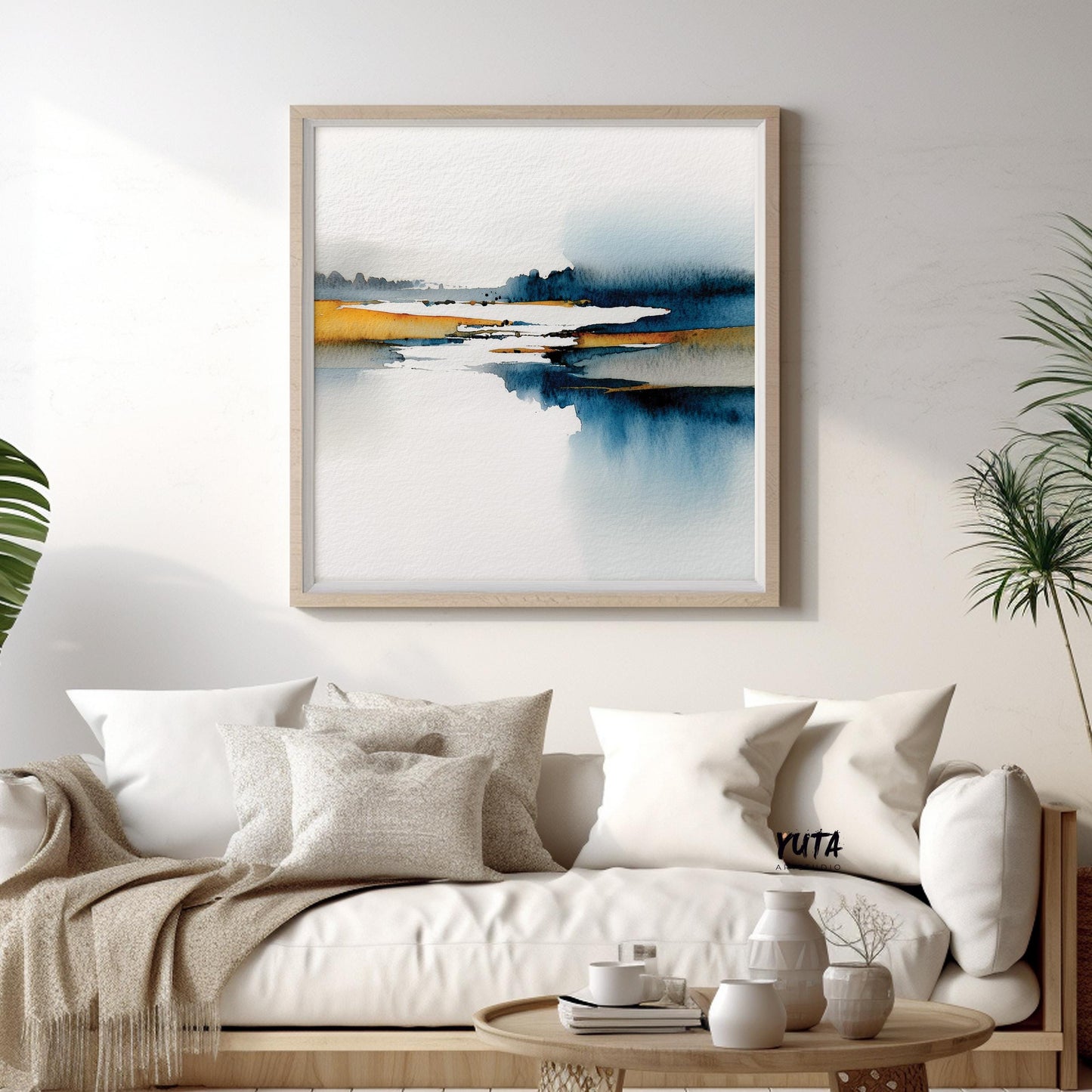 Modern abstract landscape painting framed in light wood with blue and yellow tones.