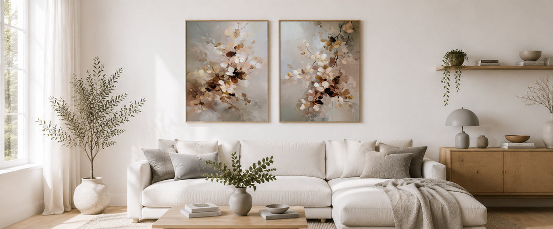 Scandinavian-style living room with two blank neutral wall art mockups on a white wall, featuring soft gray accents, natural wood furniture and bright minimalist décor.