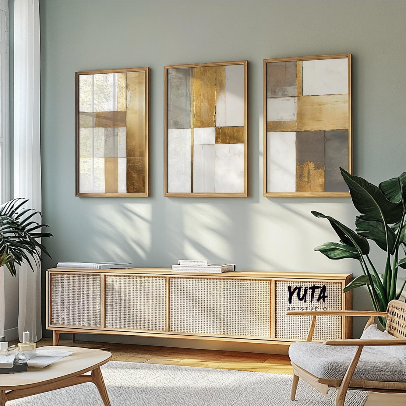 Geometric abstract wall art trio in gold frames, aligned above a minimalist sideboard
