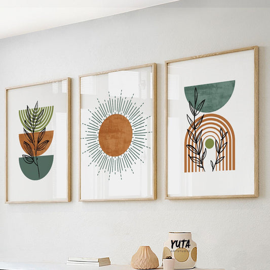 Boho abstract art trio in wood frames displayed above a white sideboard with ceramics