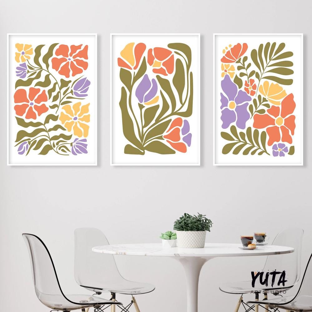 Three framed Matisse-inspired floral prints in a minimalist gallery arrangement above a round table