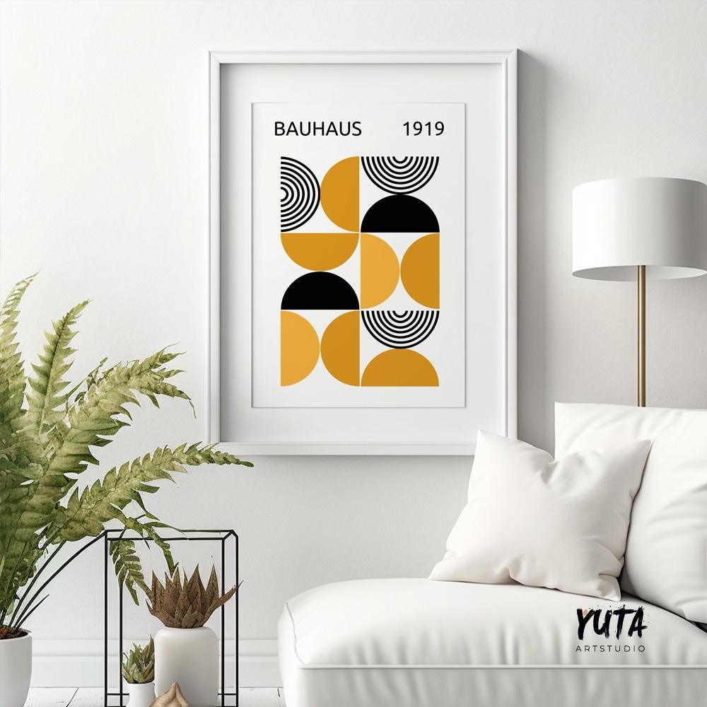 Mustard yellow Bauhaus geometric print in a white frame above plants and ceramics