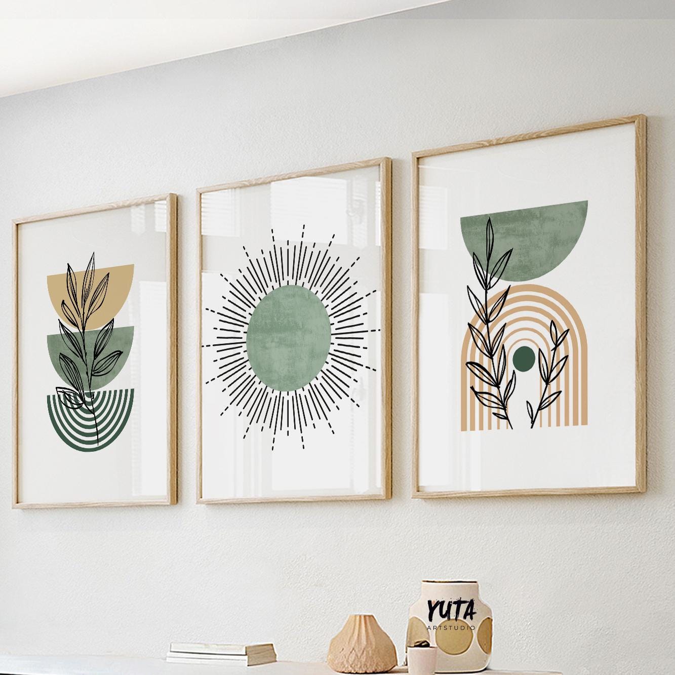 Wall art size guide showing three framed boho prints above decorative ceramics and books