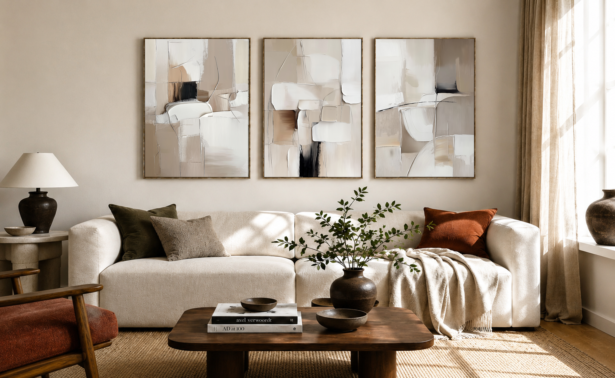 Modern living room with a white sofa and a set of three neutral minimalist abstract wall art prints in warm beige and cream tones.
