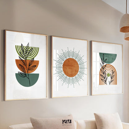 Set of three framed boho prints in terracotta and green displayed above a sofa