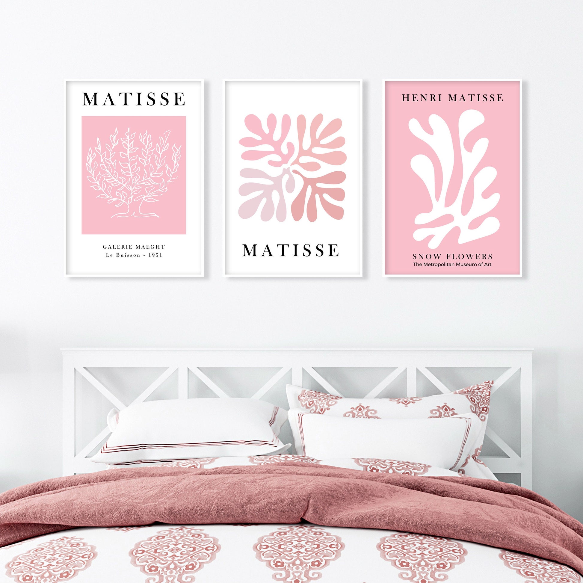 Set of three framed pink Matisse art prints in a minimalist gallery arrangement above a bed