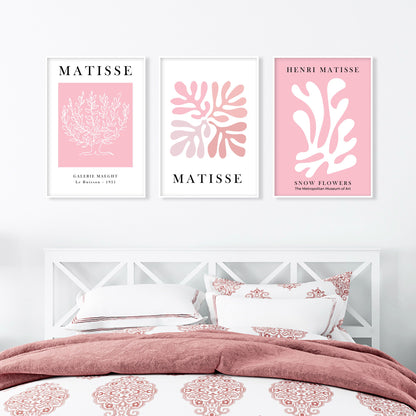 Set of three framed pink Matisse art prints in a minimalist gallery arrangement above a bed