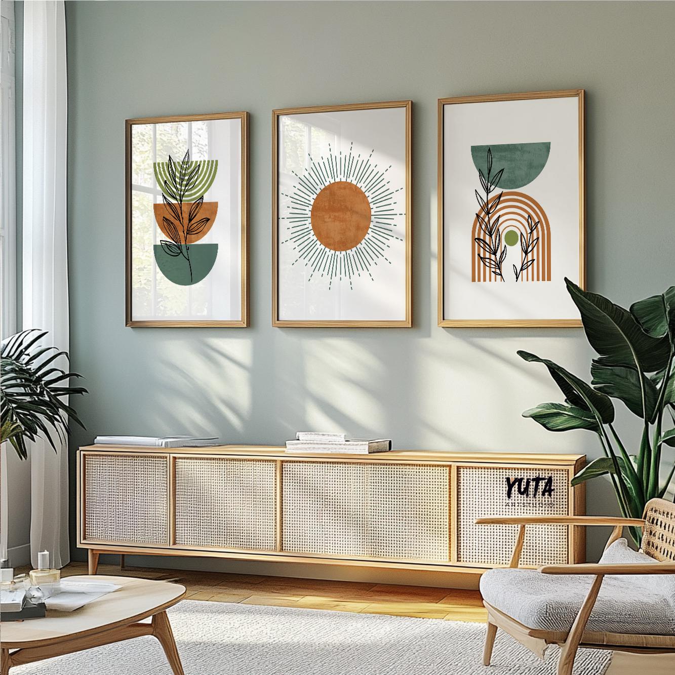 Three framed abstract boho prints in terracotta and green displayed above a woven bench.