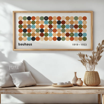 Framed Bauhaus-inspired geometric print with colorful circles displayed above a wooden console