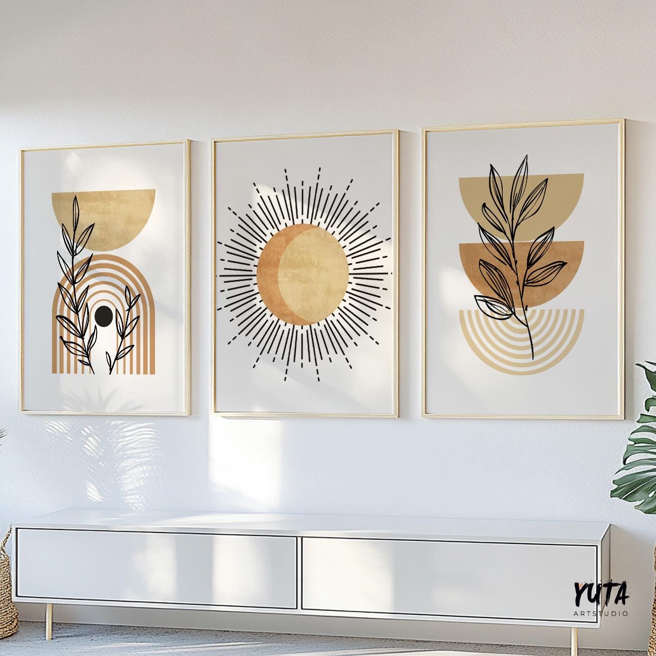 Trio of framed boho prints in terracotta beige above a sideboard for size reference