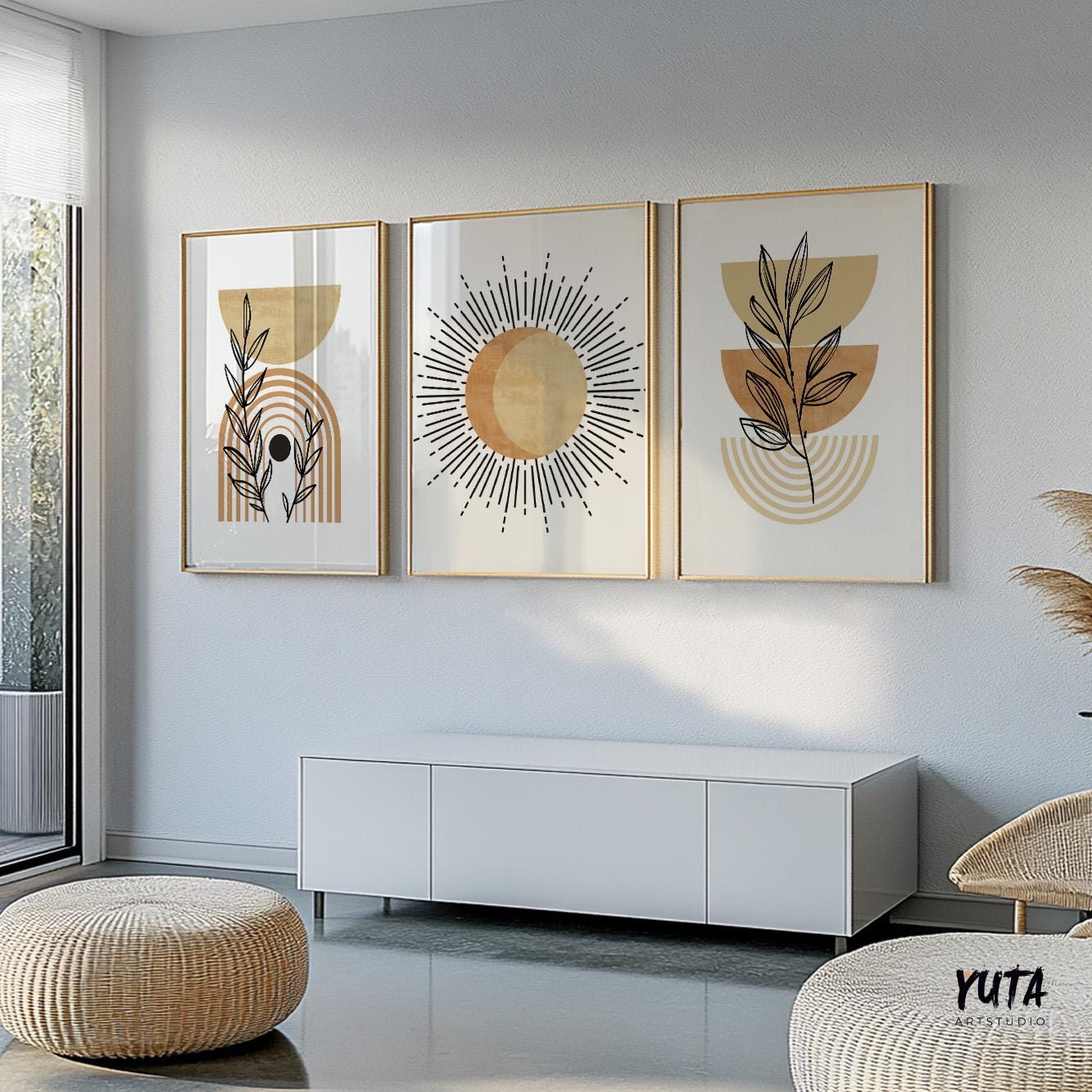 Framed terracotta abstract prints in a trio above a natural woven ottoman and seating area
