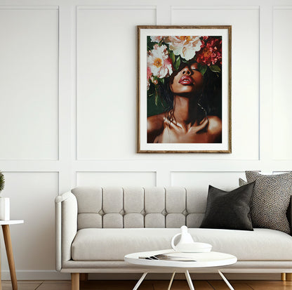 Black woman flower portrait featuring a woman beneath a dramatic arrangement of pink and red flowers