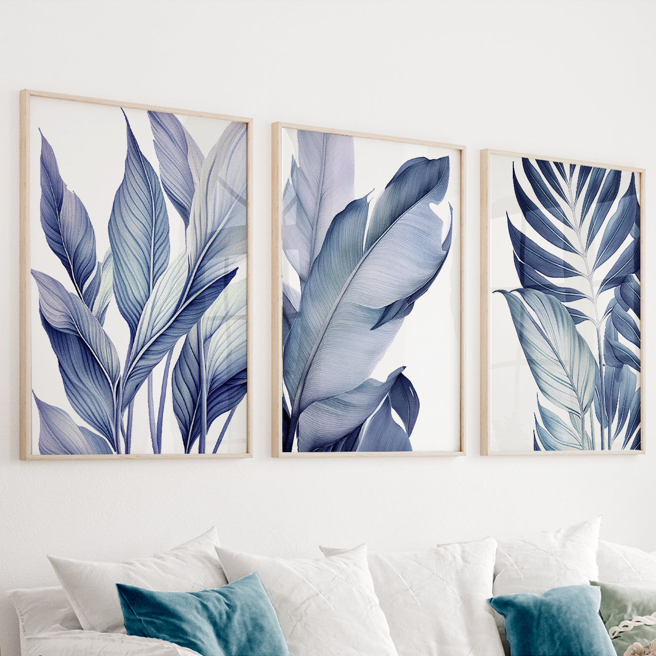 Blue botanical wall art set of 3 featuring elegant tropical leaves in soft navy and dusty blue tones