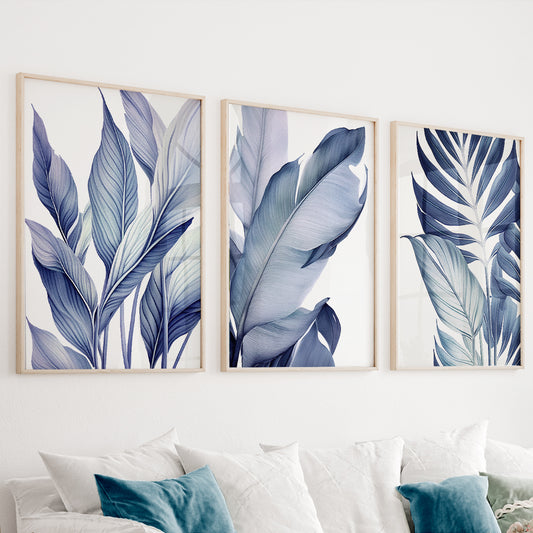 Blue botanical wall art set of 3 featuring elegant tropical leaves in soft navy and dusty blue tones
