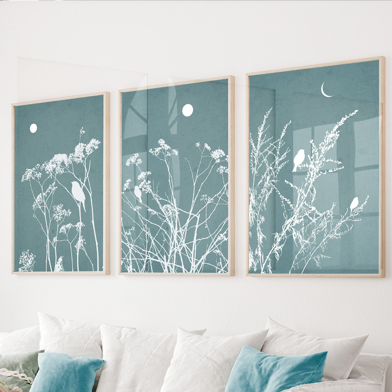 Blue botanical wall art set of 3 featuring wildflowers and perched birds on dusty blue backgrounds