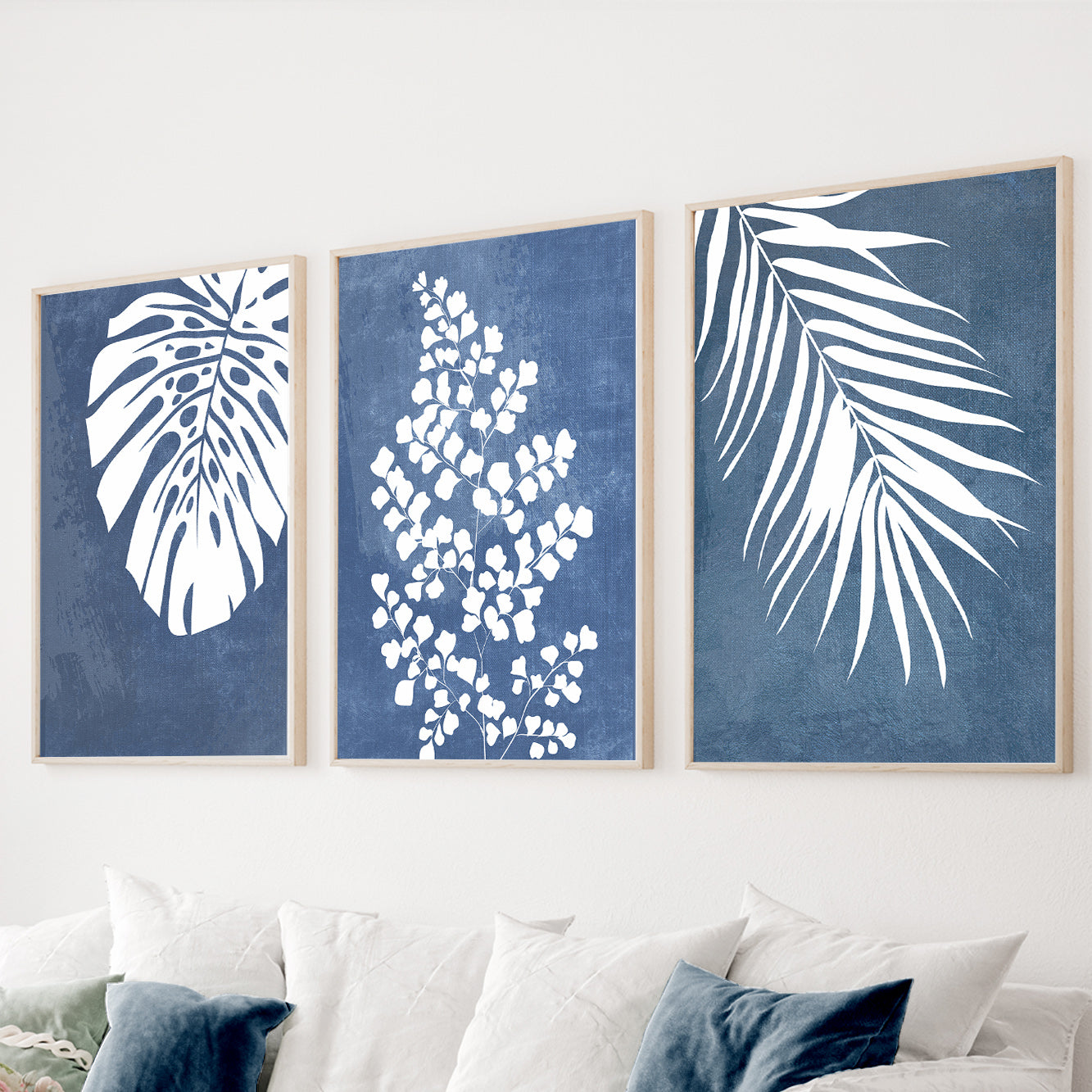 Blue botanical wall art set of 3 featuring tropical monstera leaves and botanical silhouettes
