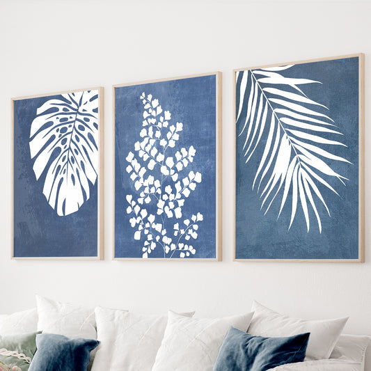 Blue botanical wall art set of 3 featuring tropical monstera leaves and botanical silhouettes
