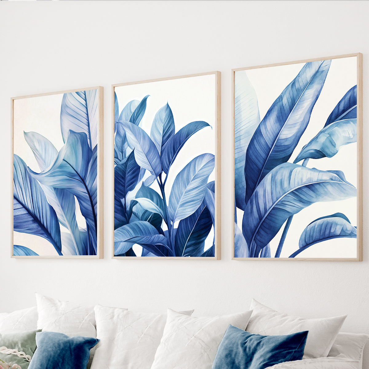 Blue botanical wall art set of 3 featuring large tropical leaves in navy, cobalt and soft blue tones.
