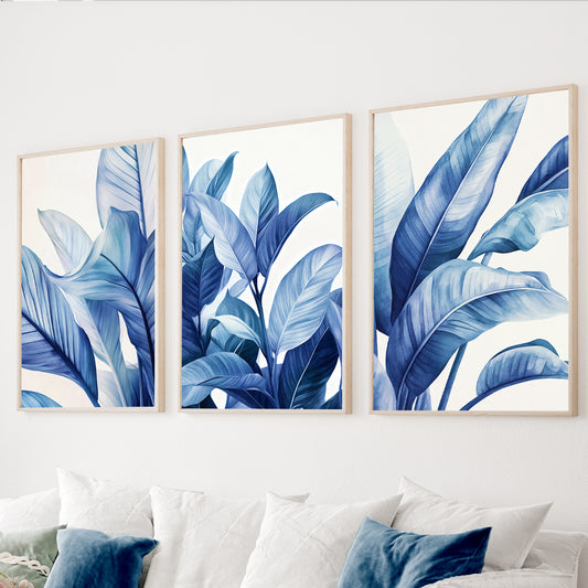 Blue botanical wall art set of 3 featuring large tropical leaves in navy, cobalt and soft blue tones.