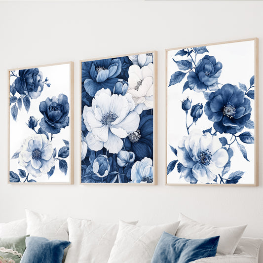 Blue floral wall art set of 3 featuring navy and white watercolor flowers with botanical leaves on white backgrounds.