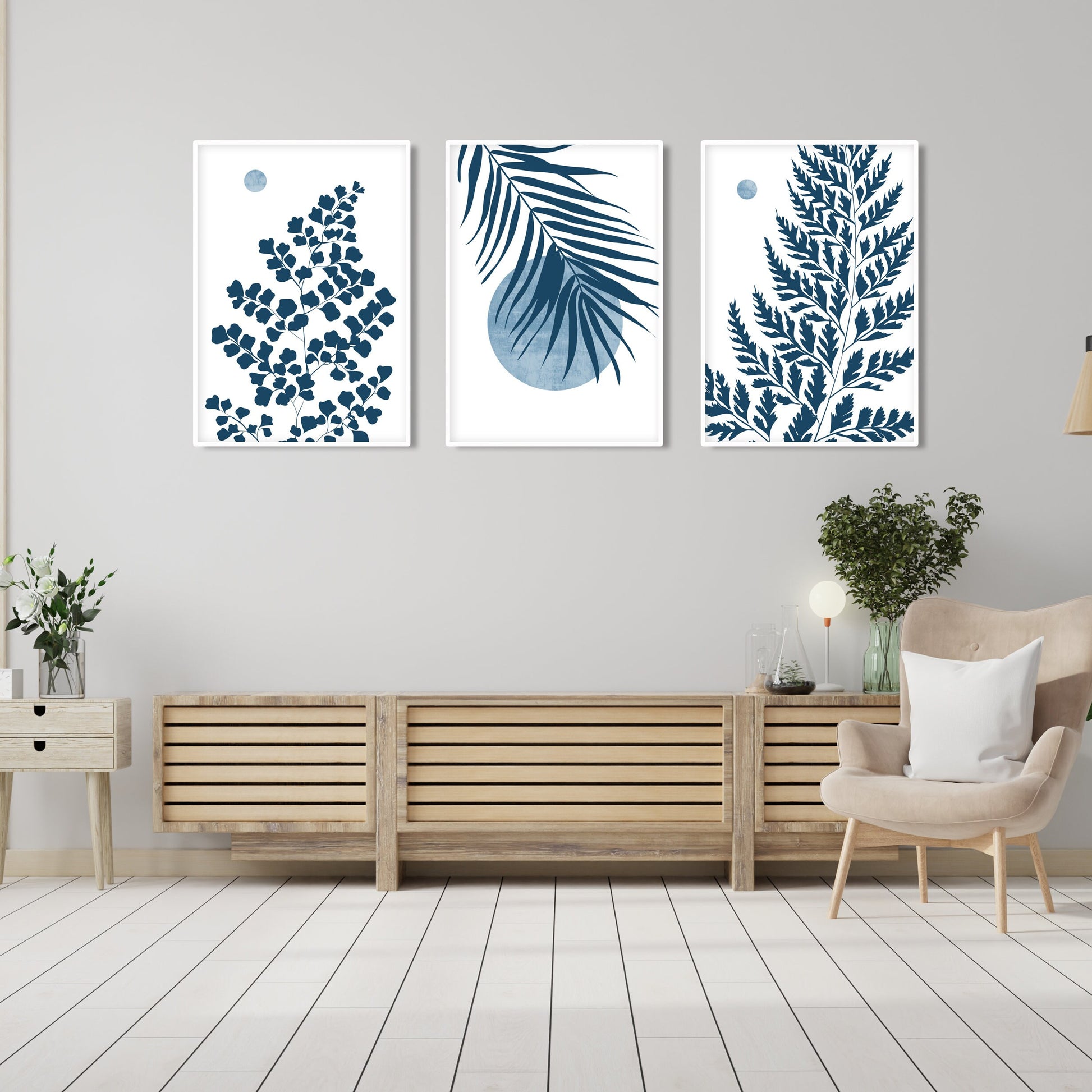 Blue wall decor featuring botanical leaf artwork, tropical foliage and modern minimalist composition