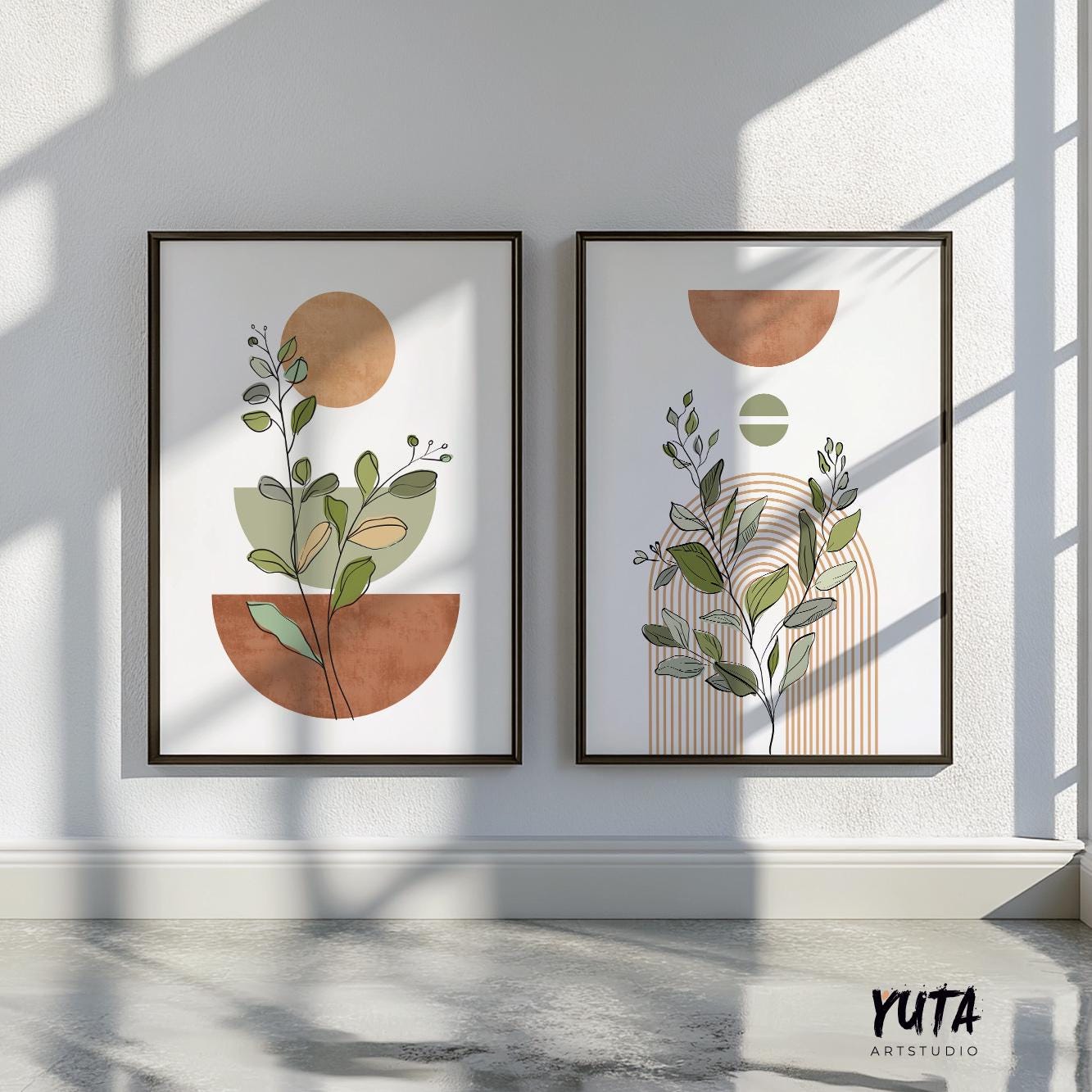 Abstract botanical art prints in terracotta tones displayed in slim black frames on a sunlit wall