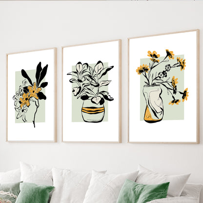 Botanical wall art set featuring floral vases and leafy plants in mustard and sage green