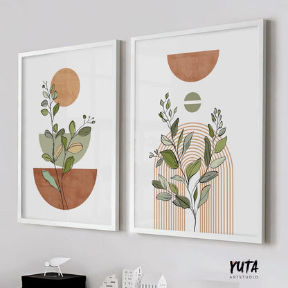 Abstract botanical art prints with terracotta shapes in white frames above stacked books and ceramics