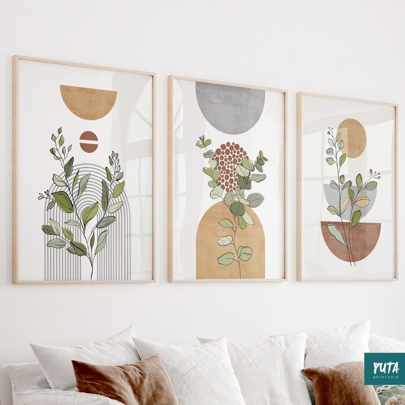 Three framed botanical abstract art prints in neutral tones displayed above a sofa