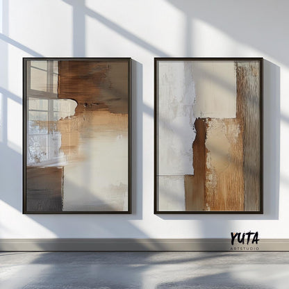 Pair of framed neutral abstract prints in beige and brown, displayed on a sunlit wall