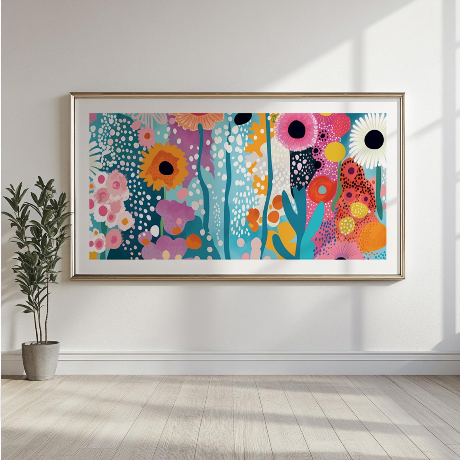 Large framed abstract floral artwork with bold colors and organic shapes on a white wall