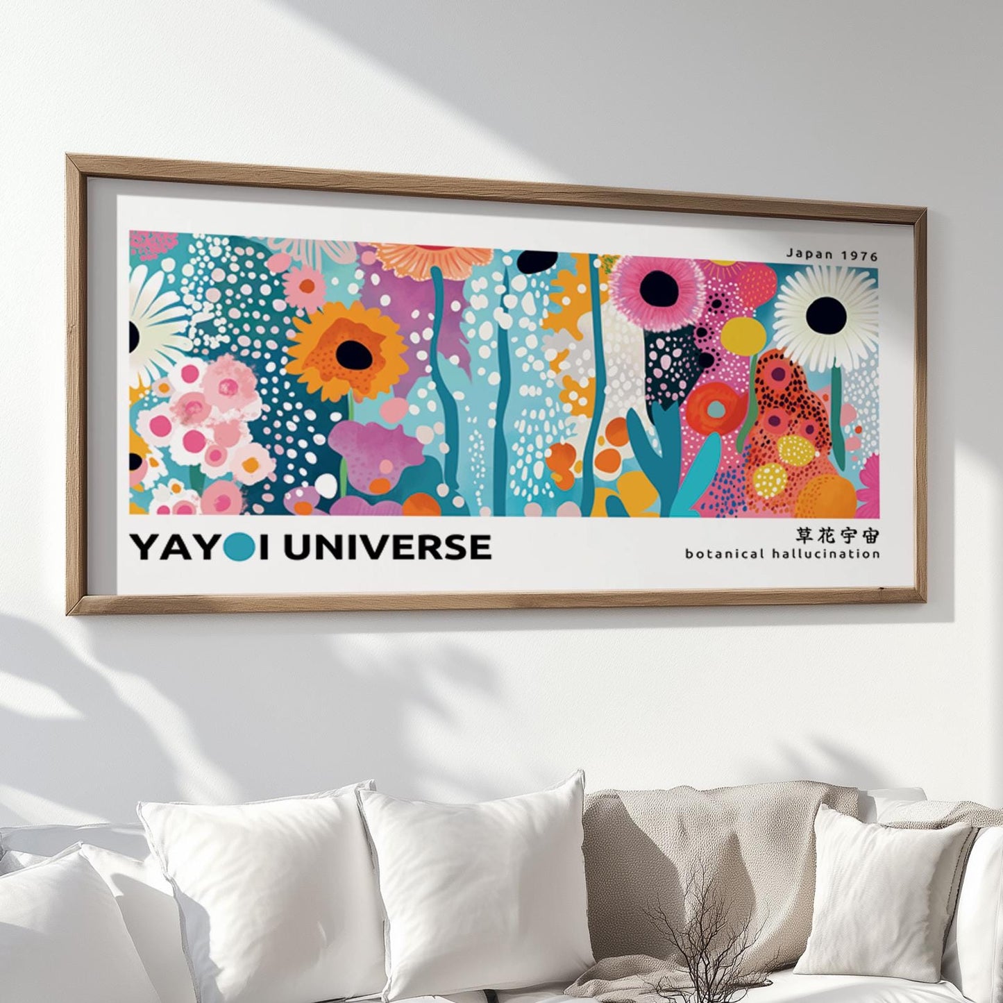 Colorful floral abstract print in a natural wood frame displayed above a white sofa.
