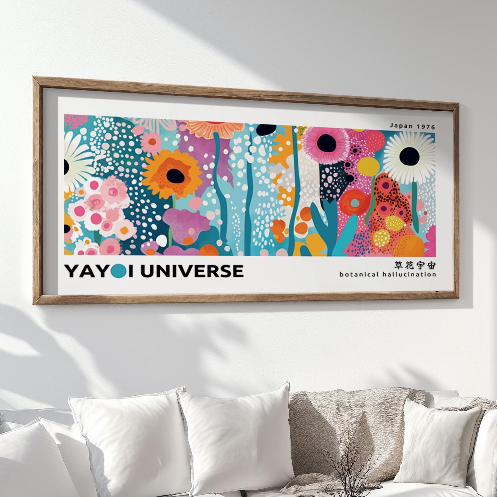 Colorful floral abstract print in a natural wood frame displayed above a white sofa.