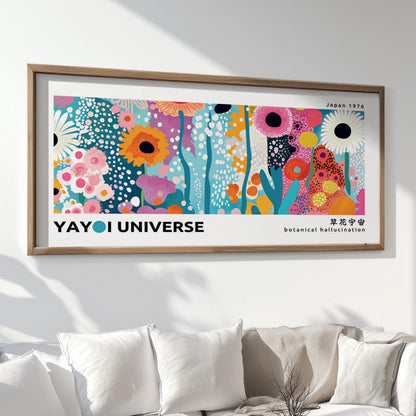 Colorful floral abstract print in a natural wood frame displayed above a white sofa.