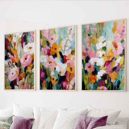 Colorful floral wall art set of 3 featuring expressive pink, orange, white and blue flowers with lush green accents.