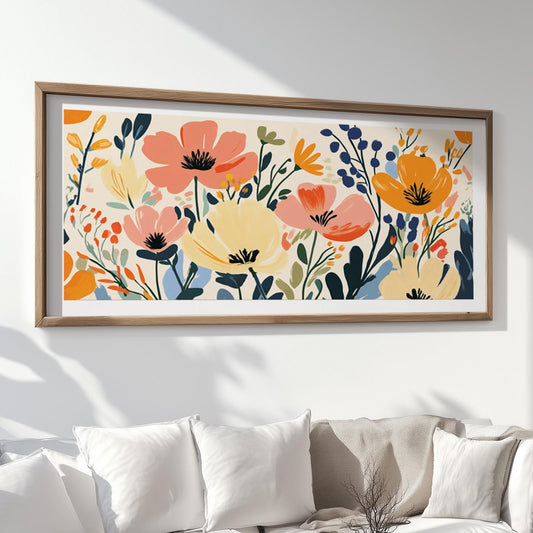 Floral abstract artwork in vibrant tones, framed in wood and hung above white cushions