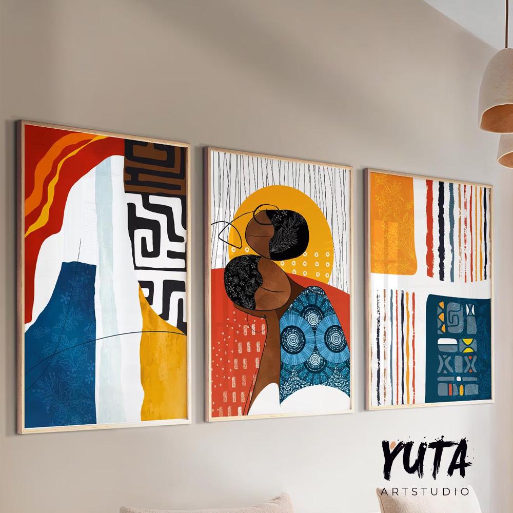 Tribal abstract framed art trio with central portrait, styled above a modern cabinet.