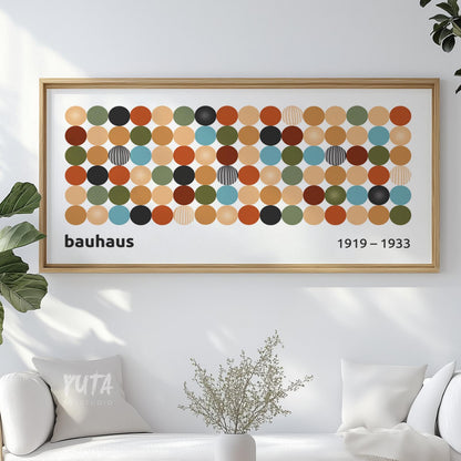 Framed Bauhaus geometric print with colorful circles hung above a white sofa.