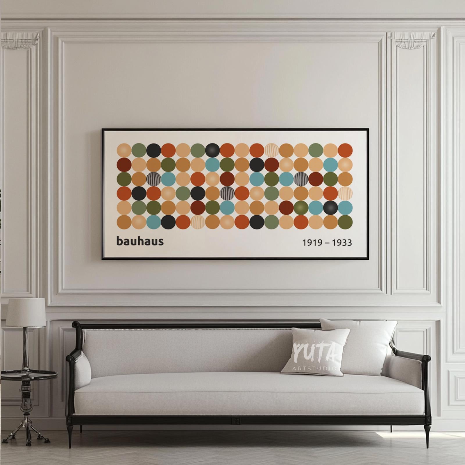 Framed Bauhaus-inspired geometric print with multicolored circles above a classic sofa.