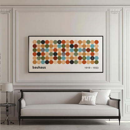 Framed Bauhaus-inspired geometric print with multicolored circles above a classic sofa.