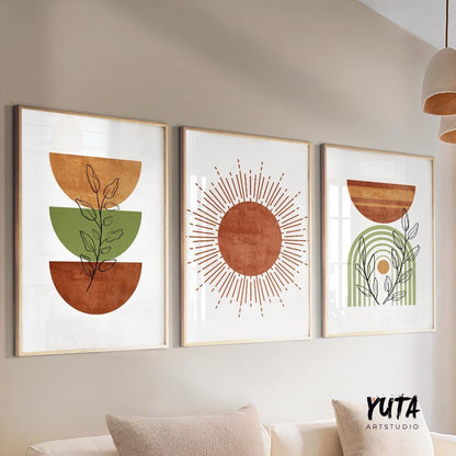 Three framed mid-century modern abstract prints arranged above a neutral sofa