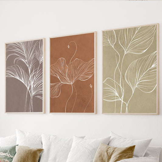 Earthy botanical wall art set of 3 featuring white leaf line drawings on taupe, terracotta and sage green backgrounds.