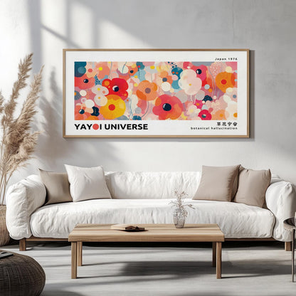Vibrant framed floral print with abstract pink and orange flowers above a white sofa in sunlit room.