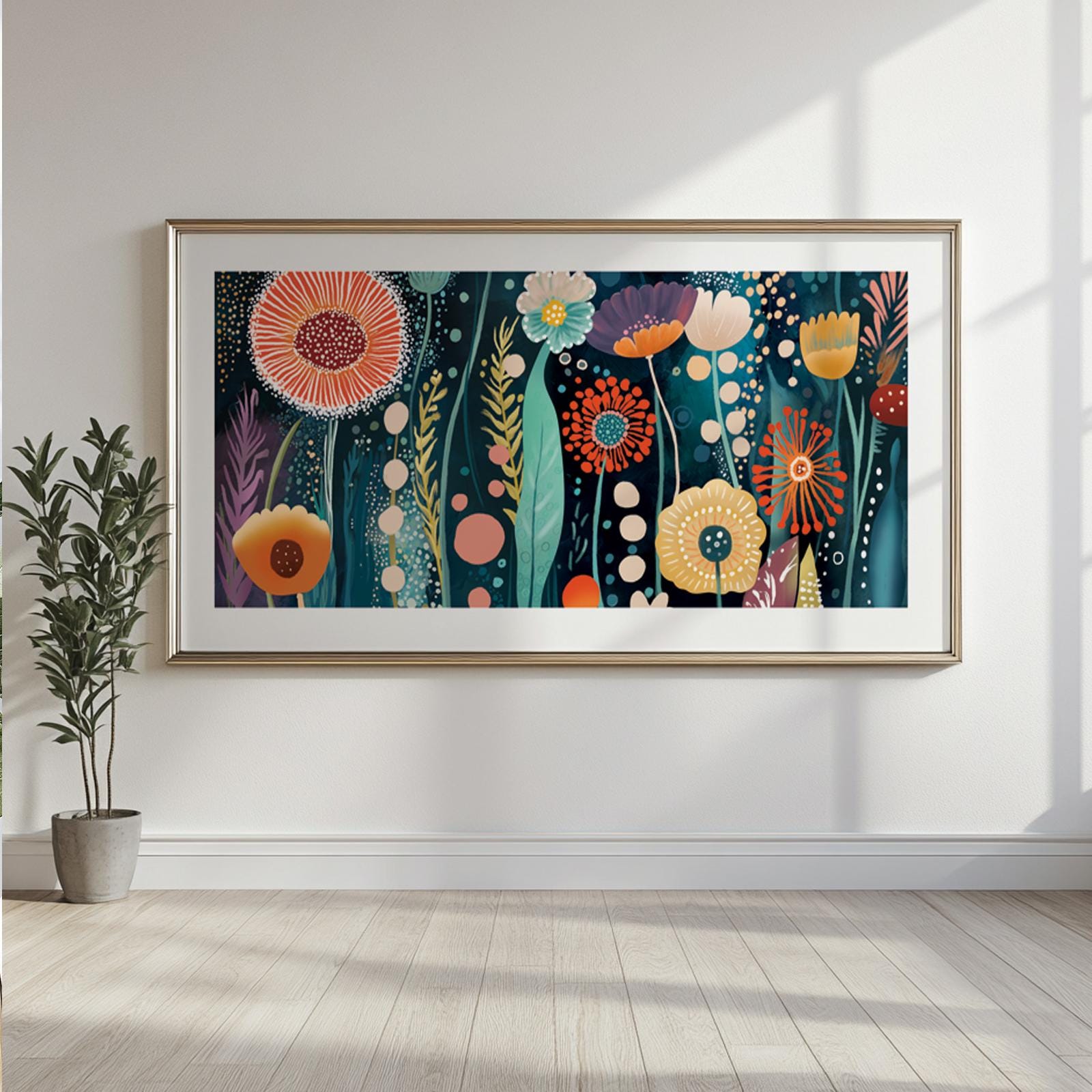 Abstract floral artwork with bold colorful flowers in a white frame above a console planter.