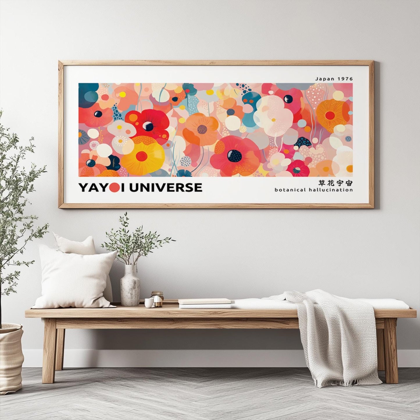 Contemporary floral print in vivid colors, framed in light wood and hung above a bench.