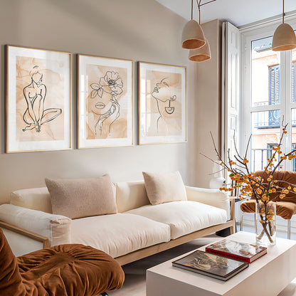 Neutral gallery wall featuring contemporary feminine line drawings and floral artwork