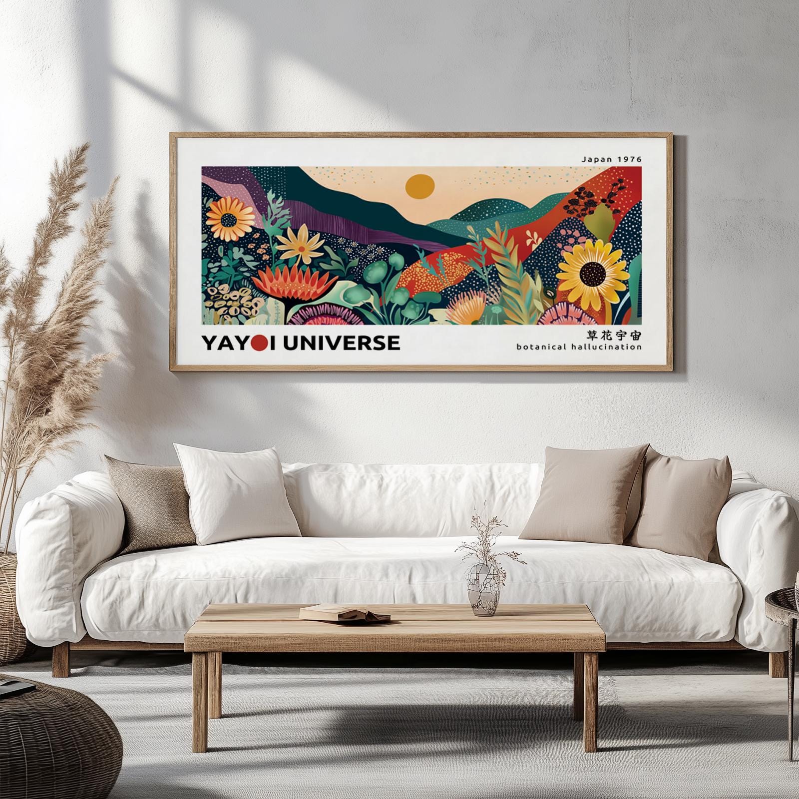 Large framed botanical landscape print in color displayed above a white sofa on a neutral wall