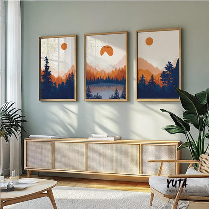 Forest landscape wall art featuring deep blue pine trees, warm orange mountain silhouettes and a tranquil wilderness scene