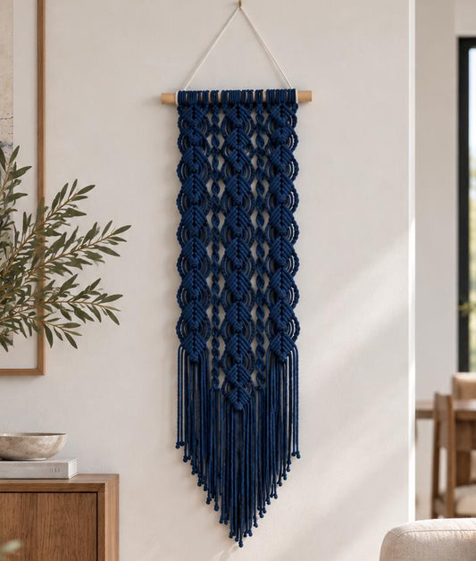 Handmade dark blue macrame wall art displayed in a modern neutral living room